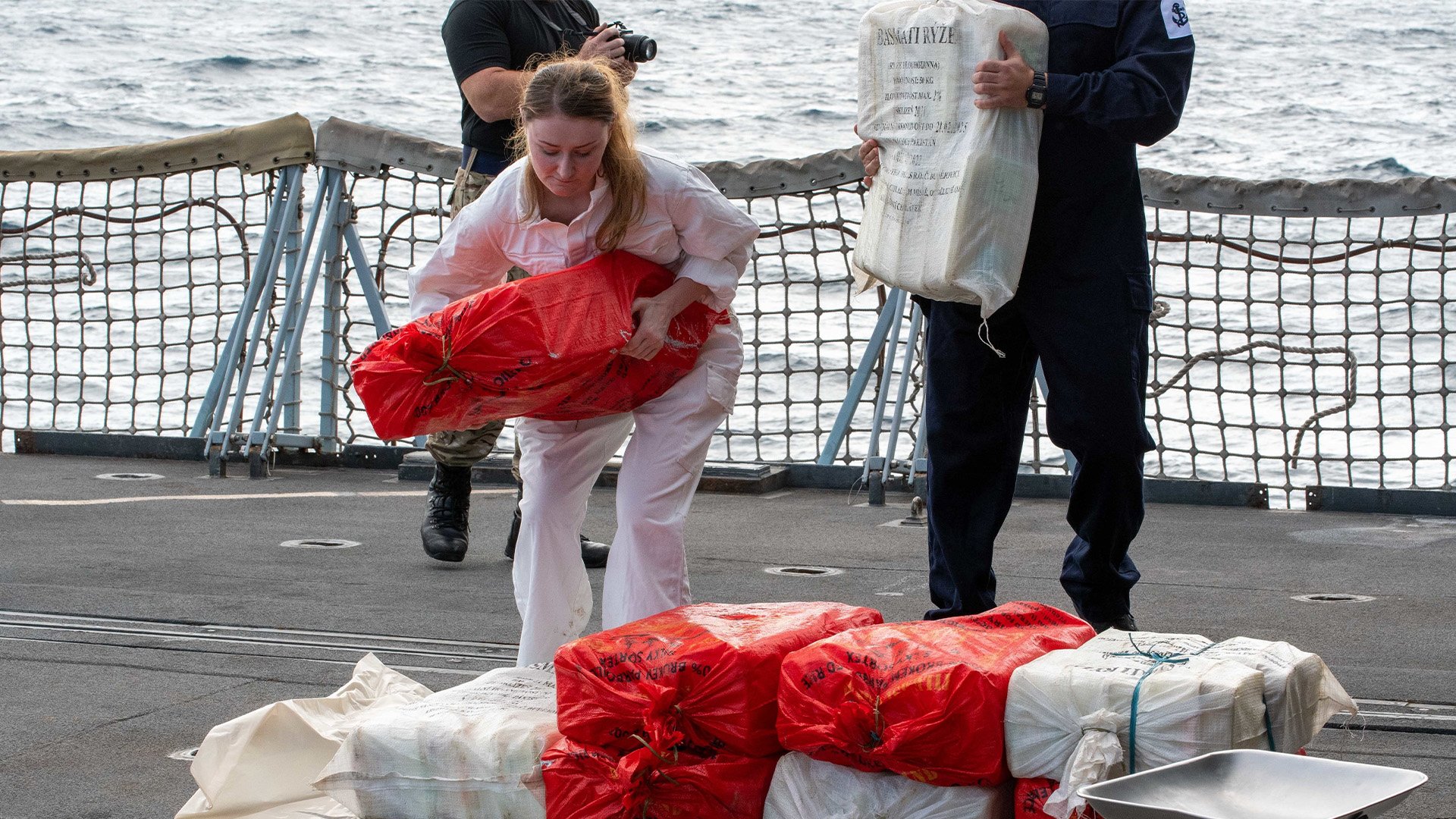 Sailors from the Royal Navy frigate Montrose inventory illicit drugs seized from a fishing vessel in international waters in the Gulf of Oman, Oct. 2., 2022. UK Royal Navy photo.
