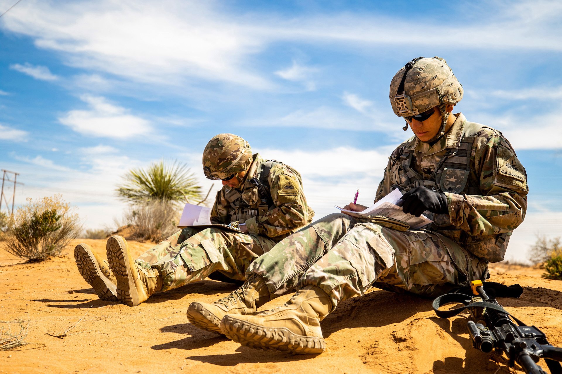 Spc. Salvador Osorio and Sgt. David Brewer, infantrymen with the 3rd Battalion, 41st Infantry Regiment, 1st Brigade Combat Team, 1st Infantry Division, plot location points during the land navigation portion of the Expert Infantryman Badge testing at Fort Bliss, Texas, March 4, 2019. US Army photo by Spc. Matthew J. Marcellus.