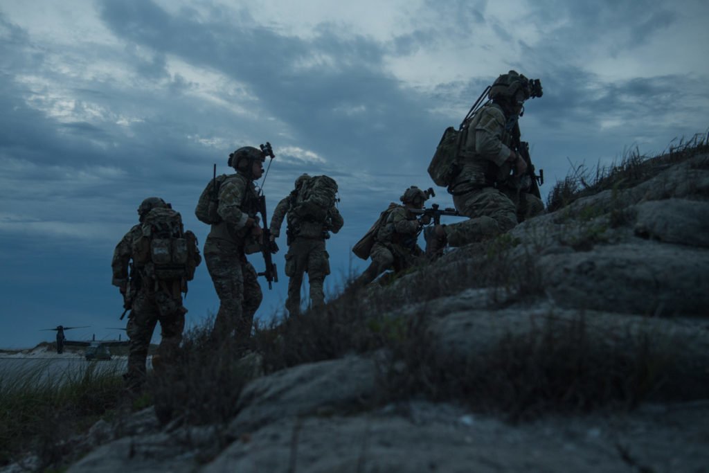 U.S. Air Force Special Tactics operators spread out on a berm to provide security at the landing zone and observe their target during operability training with 14th Weapons Squadron air assets at Eglin Range, Florida, April 22, 2020. Photo by Staff Sgt. Rose Gudex/U.S. Air Force.