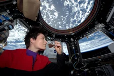 European Space Agency astronaut Samantha Cristoforetti sips espresso from the space cup, which was designed to study the capillary effects of drinking in microgravity. NASA photo.