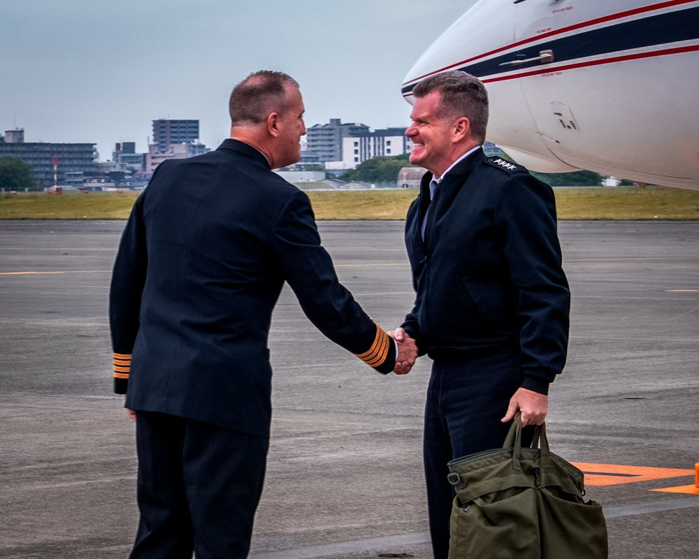 Adm. Samuel Paparo (Right), Commander, U.S. Pacific Fleet, is greeted by Capt. Manning Montagnet (Left).