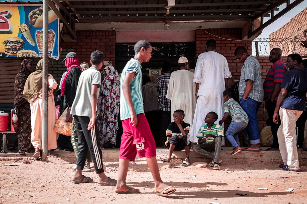 People line up in front of a bakery during a cease-fire in Khartoum, Sudan
