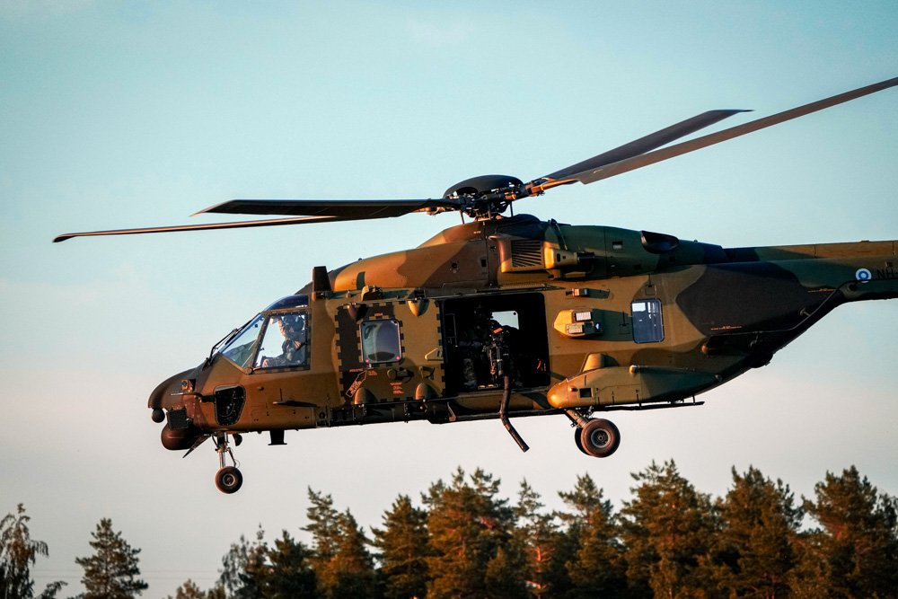 Military helicopter hovers in the air before arrival of U.S. President Joe Biden at Helsinki Airport.