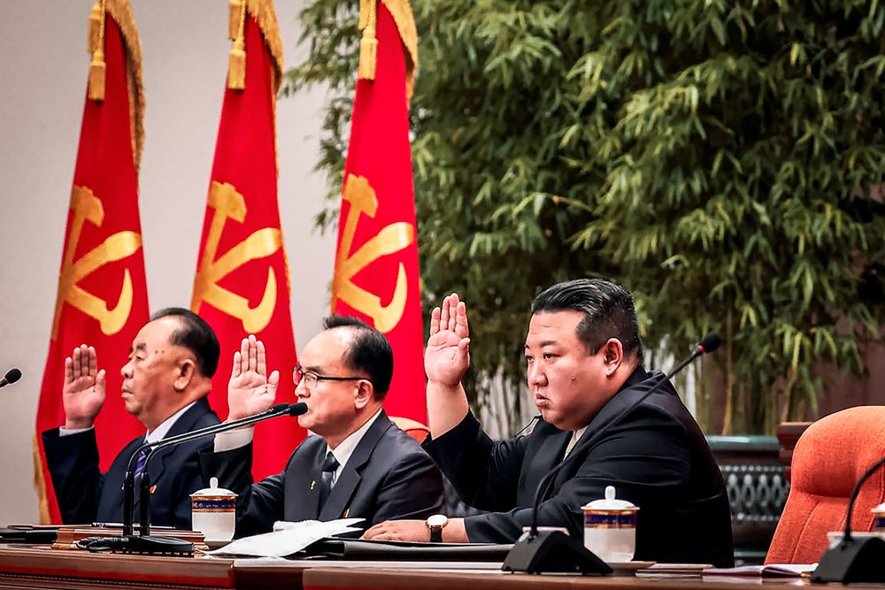 North Korean leader Kim Jong Un, center, attends an enlarged plenary meeting of the ruling Workers' Party's Central Committee.
