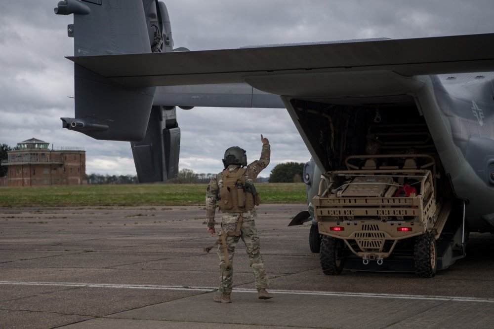 An aircrew member with the 7th Special Operations Squadron stationed at RAF Mildenhall guides an MRZR off a CV-22B Osprey during MOJO field deployable communications training with Air Force Special Tactics during exercise Valiant Liberty at RAF Sculthorpe Training Range, U.K., March 10, 2020. Special Tactics is U.S. Special Operations Command's tactical air and ground integration force, and the Air Force's only special operations ground force, leading global access, precision strike, personnel recovery and battlefield surgery operations on the battlefield. Valiant Liberty is an agile combat employment exercise which allows U.S. and allied forces to deter, defend and win across the spectrum of conflict. Photo by Staff Sgt. Rose Gudex, courtesy of the U.S. Air Force.