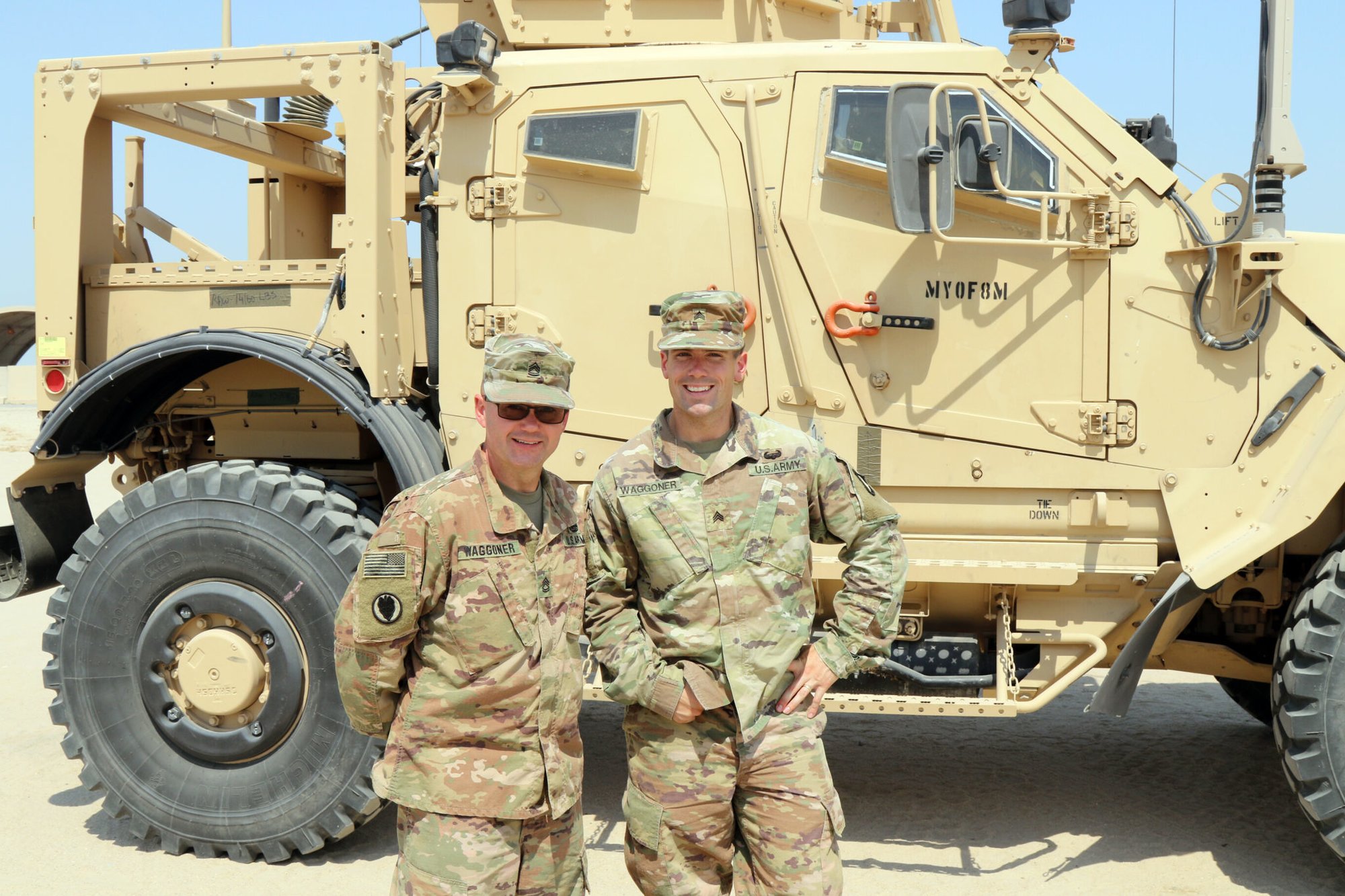 Indiana National Guard Sgt. 1st Class Teddy Waggoner, 38th Infantry Division, deployed with Task Force Spartan in Kuwait,  poses in front of a mine-resistant ambush protected light tactical vehicle with his son, Sgt. Cole Waggoner, 101st Airborne Division, during a short visit before Cole returns home to Fort Campbell, Kentucky following a 9-month deployment in Iraq.