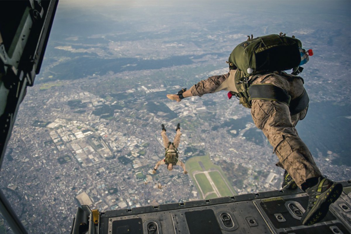 U.S. Marines assigned to the 31st Marine Expeditionary Unit exit an Air Force C-130H Hercules aircraft assigned to the 36th Airlift Squadron during a high-altitude, low-opening jump over Yokota Air Base, Japan, Aug. 11, 2014. Photo by Staff Sgt. Stephany Richards/U.S. Air Force.
