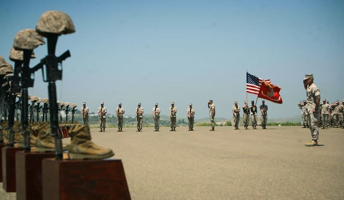 Marines with 3rd Battalion, 5th Regiment salute during the playing of taps at a memorial ceremony on April 29 at Camp Pendleton, Calif. Moments before, the Marines fired a 21-gun salute in honor of the 25 fallen warriors of the battalion.