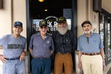 Wally King, far left, Rondo Scharfe, center left, and Bill Casassa, far right, pose with faux fellow veteran "Hank" during filming for The Final Send. Photo by Dave Reardon/Black Rifle Coffee Company.