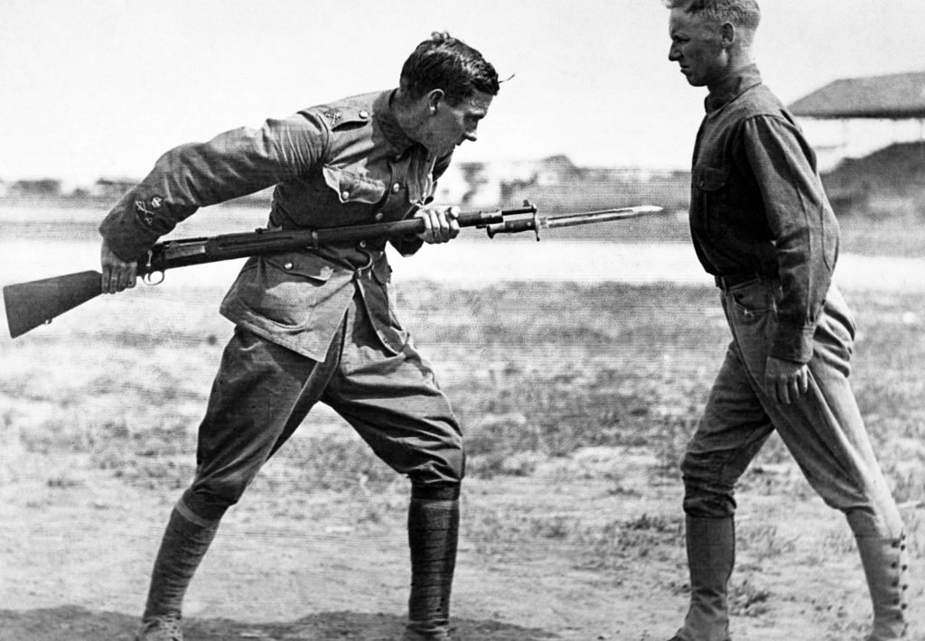 Training camp activities in 1917-1918. Bayonet fighting instruction by an English Sgt. Major, Camp Dick, Texas. War Department photo via Wikipedia.