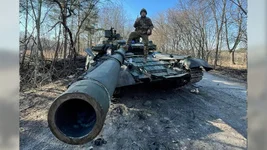 A soldier poses on a purportedly captured Russian T-80 tank. Photo courtesy of Ukrainian Weapons Tracker/Twitter.