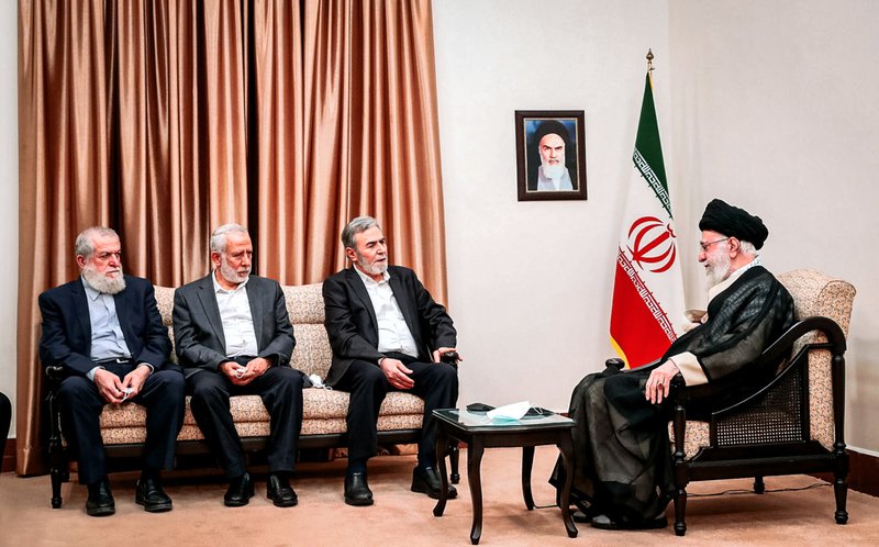 Iranian supreme leader, Supreme Leader Ayatollah Ali Khamenei, right, listens to Ziad Nakhaleh, the leader of the Palestinian Islamic Jihad group.