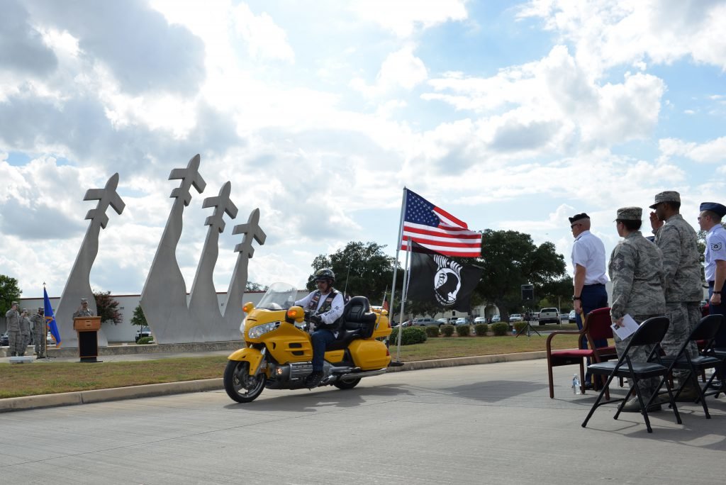 One of the Patriot Guard motorcycle riders leads a roll by to welcome those who have returned home and to honor families of those still missing. The Prisoners of War and Missing in Action wreath laying and retreat ceremonies were held at Joint Base San Antonio-Randolph Sept. 18 at the Missing Man Monument. Photo by Desiree N. Palacios/US Air Force, courtesy of DVIDS.