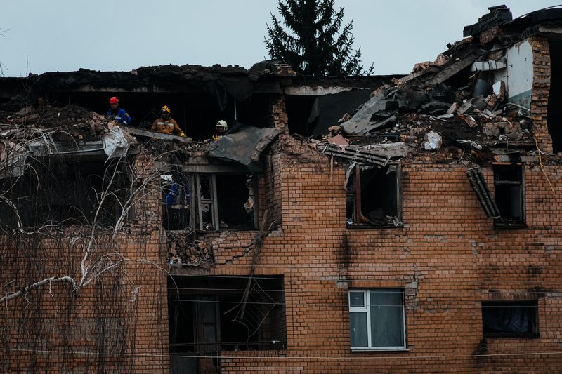 Emergency personnel work at the scene following a drone attack in the town of Rzhyshchiv, Kyiv region, Ukraine, Wednesday, March 22, 2023. (AP Photo/Efrem Lukatsky)