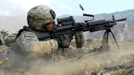 US Army Pvt. John Stafinski, a native of Seville, Ohio, fires his M249 Squad Automatic Weapon during a three-hour gun battle with insurgent fighters in Kunar province, Afghanistan’s Waterpur Valley, Nov. 3, 2009. US Army photo by Sgt. Matthew Moeller.