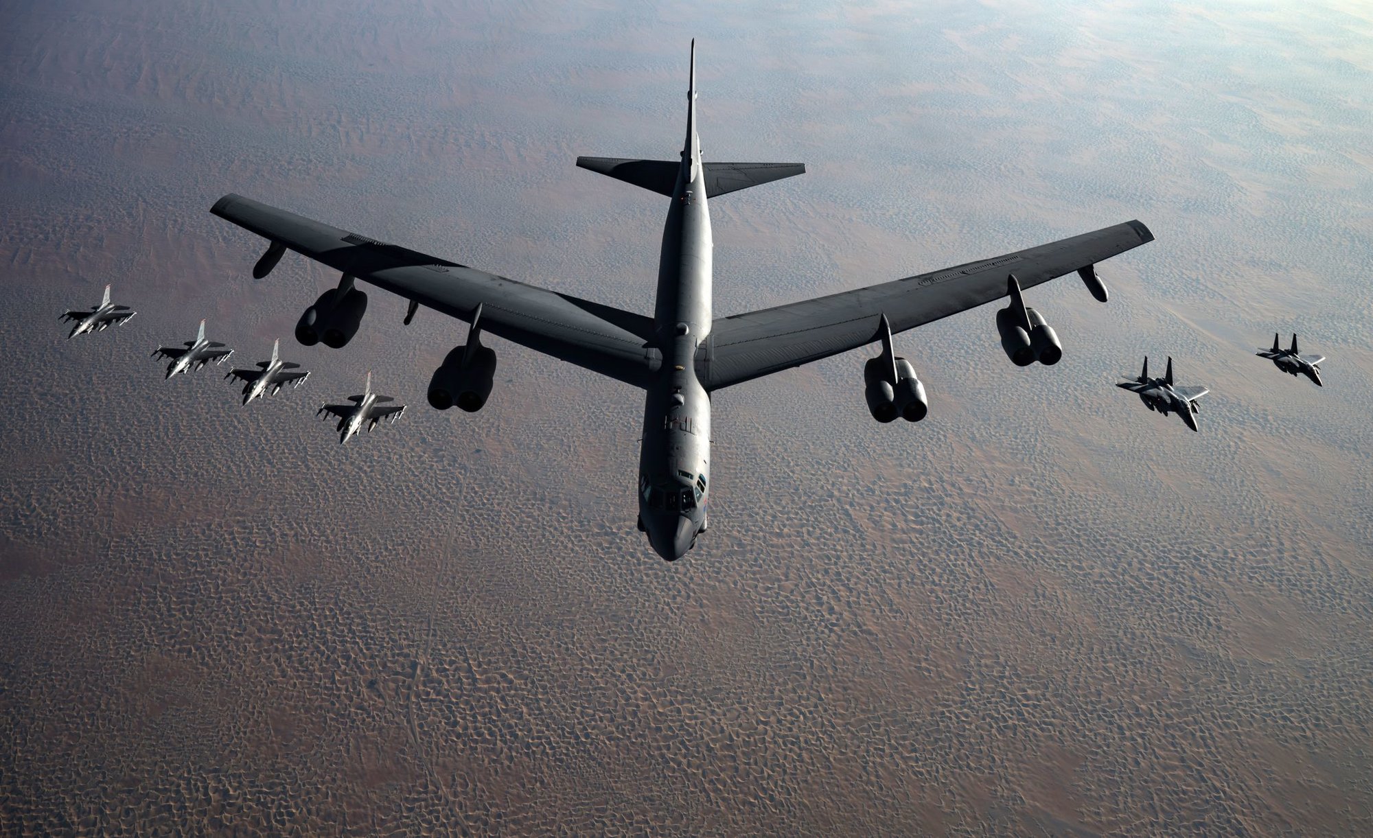 A U.S. Air Force B-52 Stratofortress flies in formation with F-16 Fighting Falcons and F-15E Strike Eagles during a Bomber Task Force mission over the U.S. Central Command area of responsibility Nov. 21, 2020. Bomber Task Force missions help aircrews gain familiarity with the region’s airspace and command and control functions and allow them to integrate with the theater’s U.S. and partner air assets, increasing the combined force’s overall readiness. (U.S. Air Force photo by Staff Sgt. Sean Carnes)