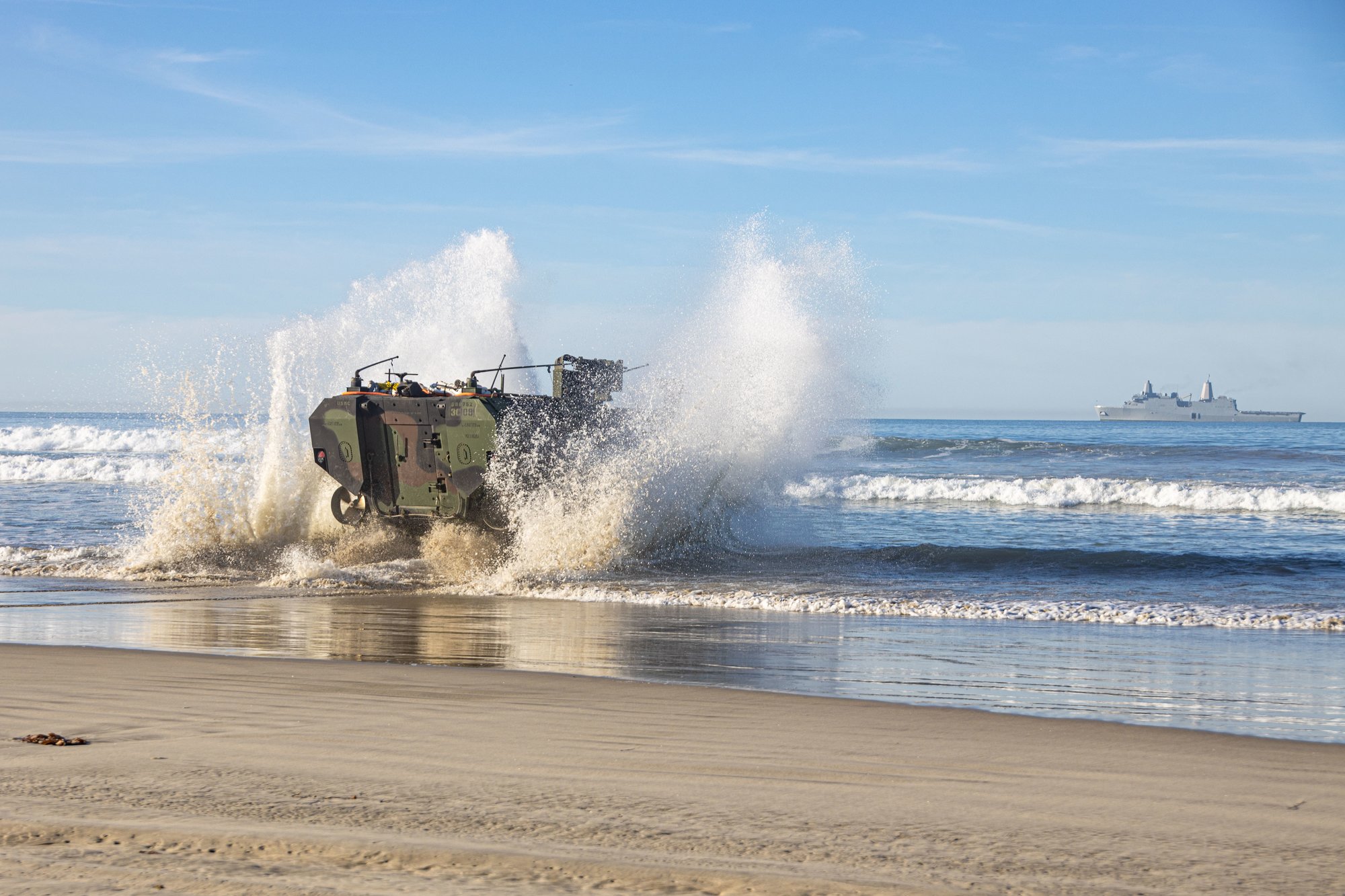 US Marines and sailors assigned to 3d Assault Amphibian Battalion, 1st Marine Division, conduct waterborne training with an Amphibious Combat Vehicle moving from shore to the amphibious transport dock ship Anchorage at Marine Corps Base Camp Pendleton, California, Feb. 12, 2022. US Marine Corps photo by Lance Cpl. Willow Marshall.