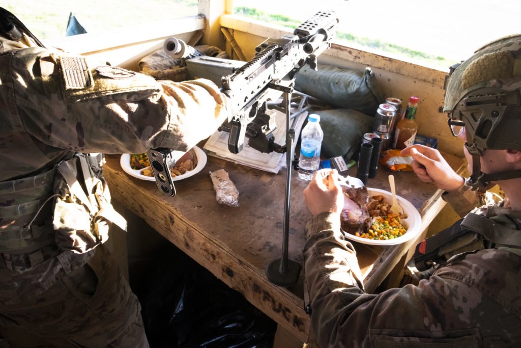 Soldiers eat dinner while on tower guard duty. Photo by Kevin Knodell/Coffee or Die.