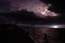 The guided-missile destroyer USS Farragut (DDG 99) transits the Gulf of Oman at night during a lightning storm on Nov. 10, 2019. US Navy photo by Mass Communication Specialist 3rd Class Jack D. Aistrup.