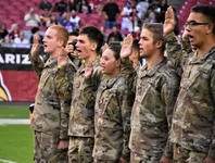 Recruits from the Phoenix Recruiting Battalion, National Guard and Marines, recite the Oath of Enlistment during a mass enlistment ceremony Dec. 1, 2019, at State Farm Stadium, Glendale, Arizona. The ceremony took place shortly before a National Football League football game between the Arizona Cardinals and Los Angeles Rams. Photo by Alun Thomas, courtesy of the U.S. Army.