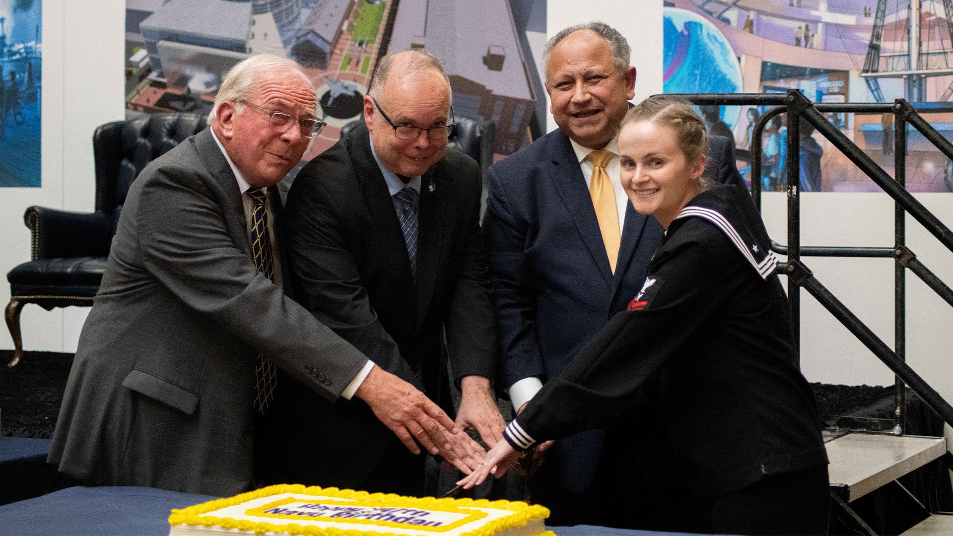 Navy Museum Development Foundation Board President Al Konetzni, a retired three-star admiral, US Naval History and Heritage Command director Samuel J. Cox, a retired rear admiral, and Secretary of the Navy Carlos Del Toro join Yeoman 2nd Class Caroline Ficklin in cutting the Navy's birthday cake at the National Museum of the US Navy dduring an event celebrating the Navy’s 247th birthday. That facility is slated to be replaced by a new museum located just outside the Washington Navy Yard. US Navy photo by Mass Communication Specialist 1st Class Abigayle Lutz.
