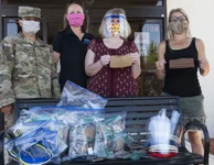 Senior Master Sgt. Natasha McCracken, First Sergeant Council, Beth Hanning, STEMWERX, Regan Zick, president, Eglin Spouses Club and Michelle Cain, ESC member, meet for a protective gear delivery April 17 at Eglin Air Force Base, Fla. The ESC donated 700 face masks and 300 face shields to Team Eglin. Since the donation, 314 items of PPE have been delivered. The deliveries will continue through the coming weeks. (U.S. Air Force photo/Ilka Cole)