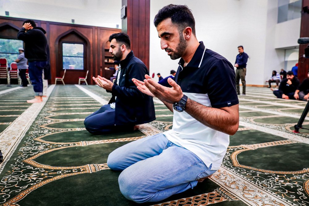 Brothers Samiullah Safi, left, and Abdul Wasi Safi pray during Friday prayers at the Al-Noor Society Mosque in Houston.