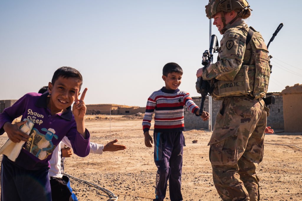 Children of the village were eager to have their picture taken. First Lt. Cailtin LaNeve smiles throughout her interactions with them.