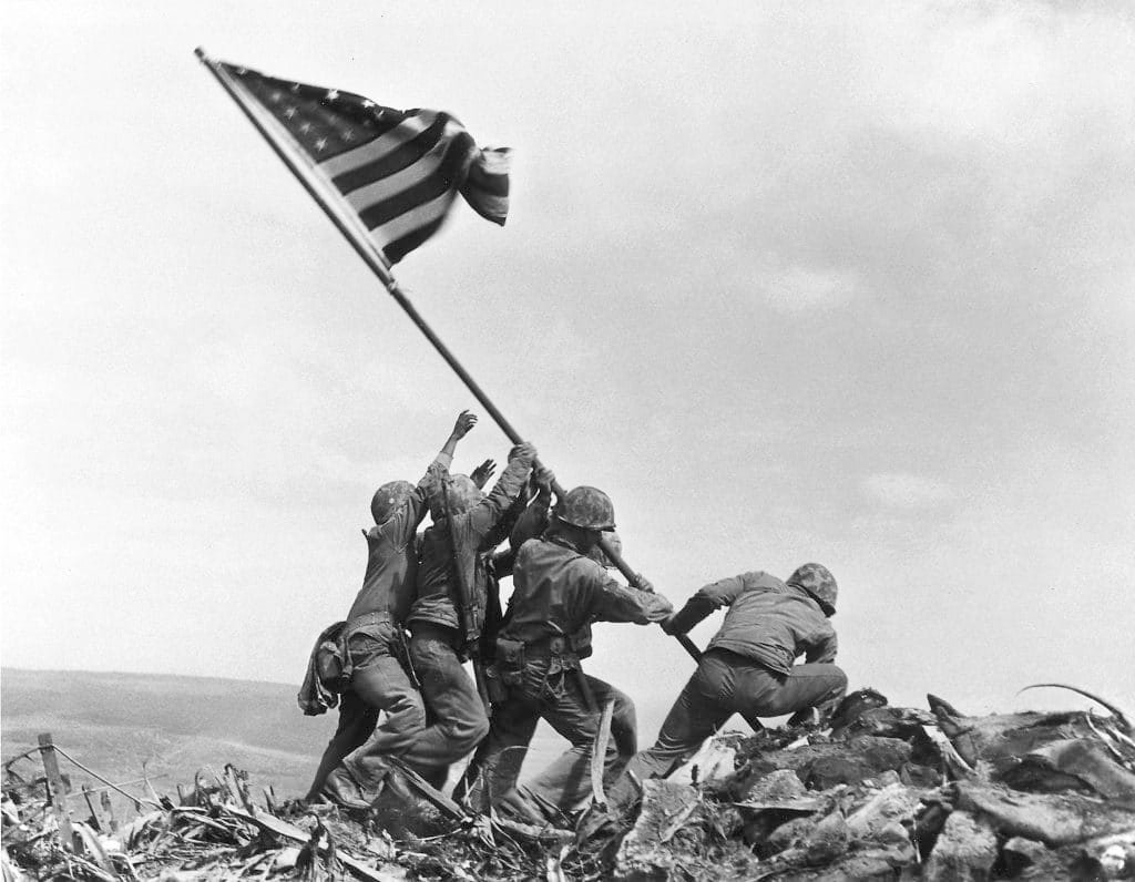 U.S. Marines raise the flag atop Mount Suribachi, Iwo Jima, Feb. 23, 1945. Photo by Joe Rosenthal/Associated Press, courtesy of the Department of Defense.
