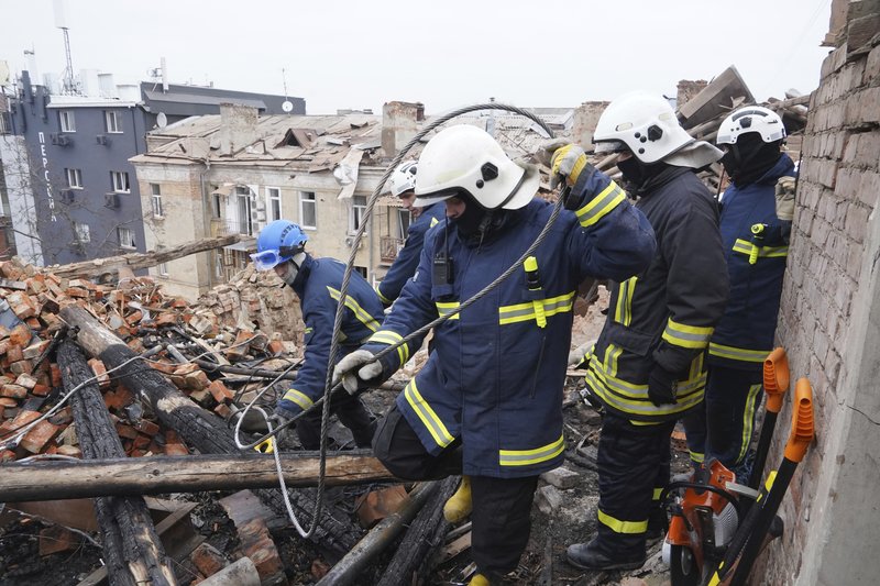 Ukrainian emergency workers clear the rubble on the roof of a residential building, which was hit by a Russian rocket at the city center of Kharkiv, Ukraine, Monday, Jan. 30, 2023. Russian shelling killed at least five people and wounded 13 others during the previous 24 hours, Ukrainian authorities said Monday as the Kremlin’s and Kyiv’s forces remained locked in combat in eastern Ukraine. AP photo by Andrii Marienko.