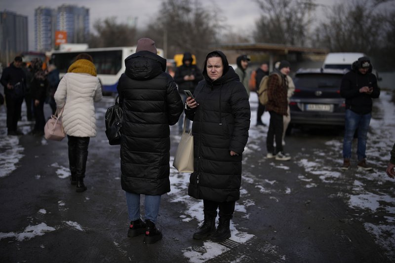 People wait on a street blocked by police after a rocket attack in Kyiv, Ukraine, Thursday, Jan. 26, 2023. AP Photo by Daniel Cole.