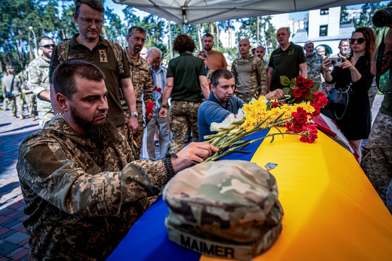 A Ukrainian serviceman pays his last respects to his comrade Nicholas Maimer, a U.S. citizen and Army veteran who was killed during fighting in Bakhmut against Russian forces.