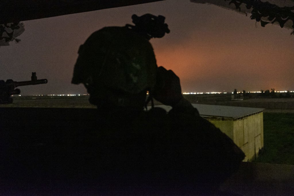Pvt. Charles on tower duty looking out. Flame from the oil fields turns the sky orange. Photo by Kevin Knodell/Coffee or Die.