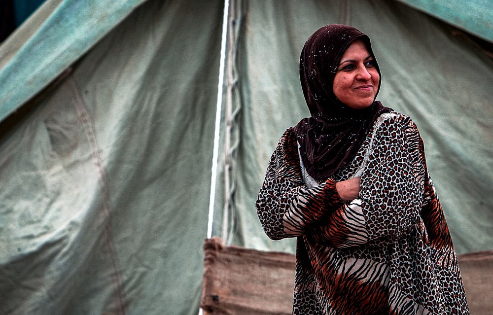 Here, an Iraqi family - refugees - takes a moment to pose for the camera.