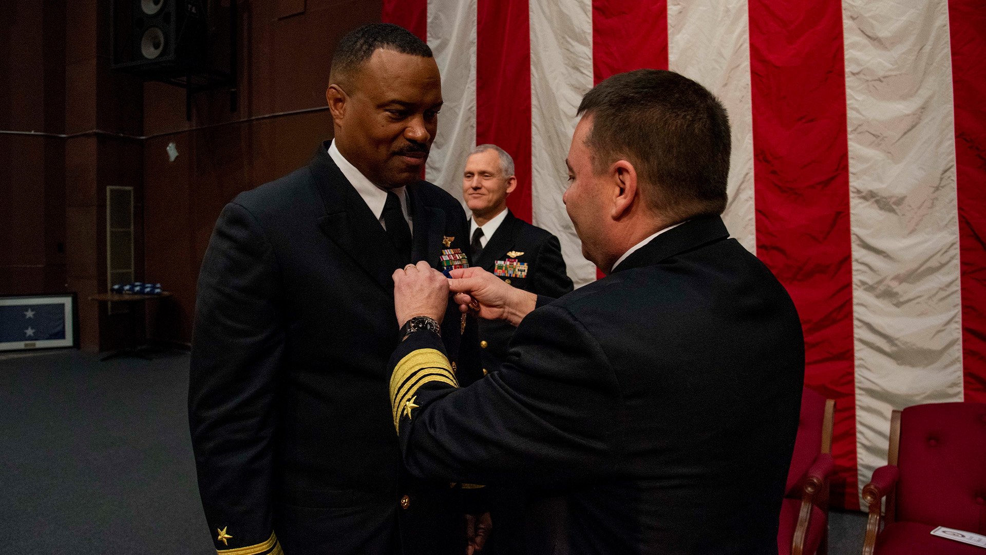 Outgoing commander of Navy Personnel Command, Rear Adm. Alvin "Bull" Holsey receives the Distinguished Service Medal from Vice Adm. Rick Cheeseman, the Chief of Naval Personnel, during a ceremony held at the Pat Thompson Conference Center at Naval Support Activity Mid-South in Millington, Tennessee. US Navy photo by Mass Communication Specialist 2nd Class Jared Catlett.