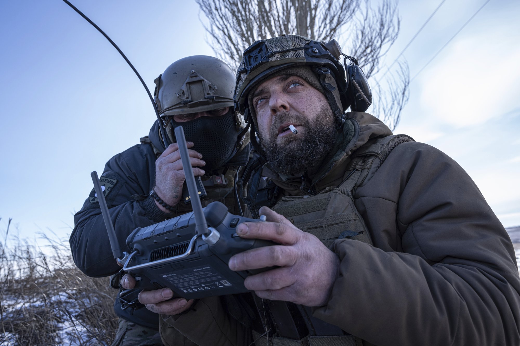 A Ukrainian serviceman aka Zakhar, right and commander of a unit aka Kurt, look on a screen of a drone remote control during fighting, at the frontline in Donetsk region, Ukraine, Monday, Feb. 13, 2023. AP photo by Evgeniy Maloletka.