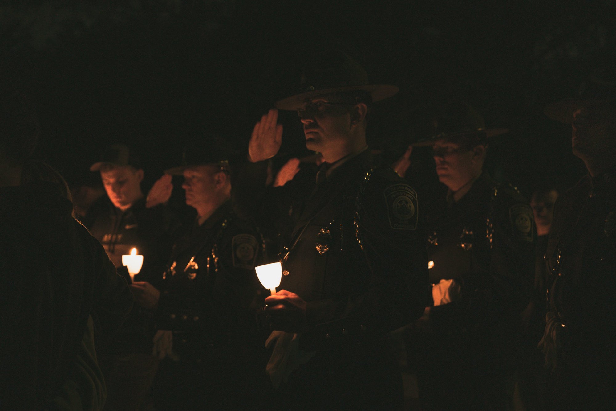 Law enforcement officers salute as names of their fallen are read. Photo by Marty Skovlund, Jr./Coffee or Die.
