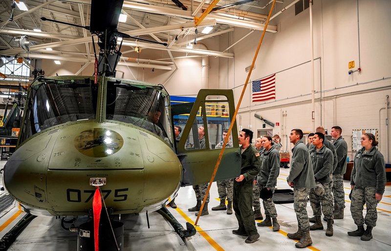Staff Sgt. Eric McElroy, 40th Helicopter Squadron special mission aviator, provides a tour of a UH-1N helicopter.