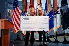 Phyllis Wilson, left, accepts the check symbolizing the $20,000 donation from Black Rifle Coffee Company with Jenna Bakken on Monday, June 12, 2023, during the Military Women's Memorial's Women Veterans Recognition Day in Washington, DC. Photo by Lauren Warner/Coffee or Die.