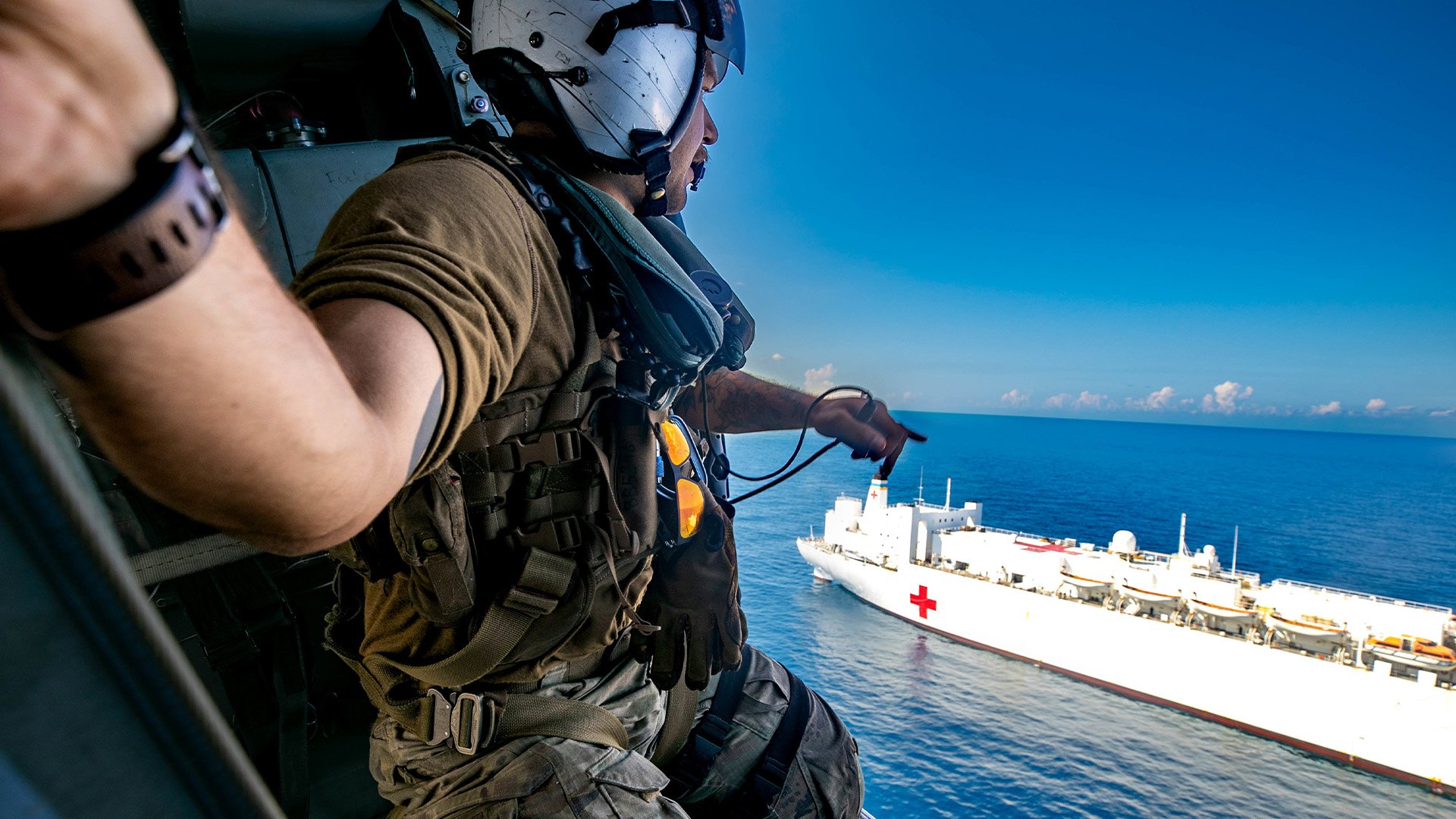 Naval Aircrewman (Helicopter) 2nd Class Bryce Batiancela, from the "Chargers" of Helicopter Sea Combat Squadron 26 Detachment 3 , monitors his aircraft's distance from the hospital ship Comfort off Haiti on Dec. 12, 2022. US avy photo by Mass Communication Specialist 2nd Class Juel Foster.