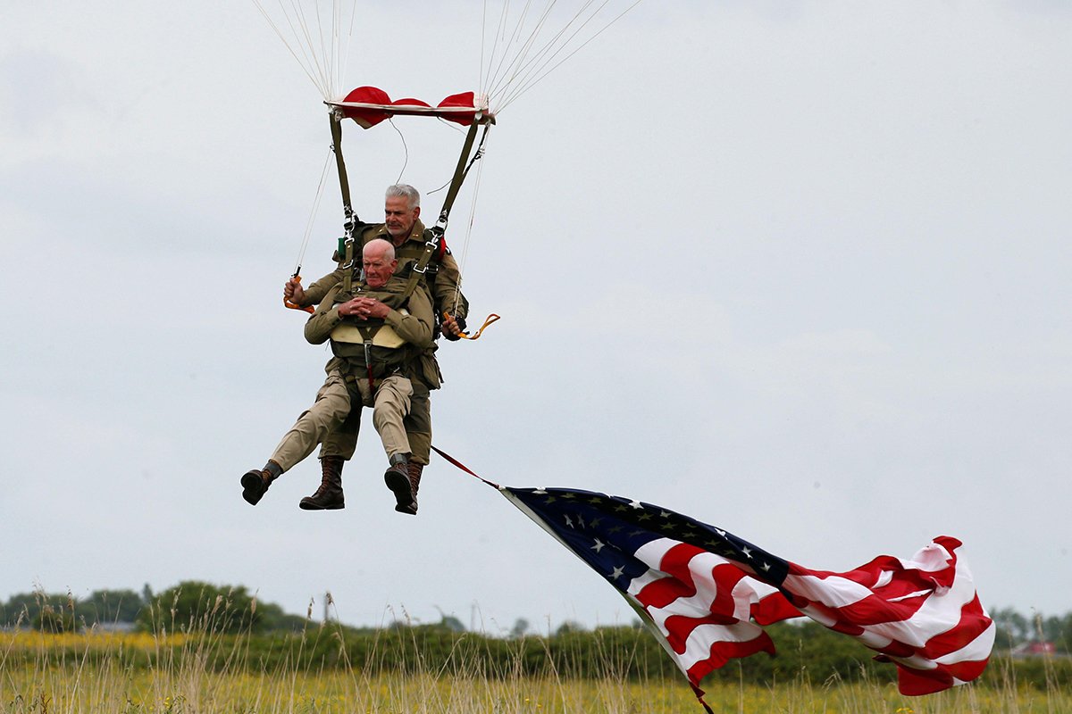 US World War II paratrooper veteran Tom Rice, 97 years old, who served with the 101st Airborne, lands during a commemorative parachute jump over Carentan on the Normandy coast June 5, 2019, ahead of the 75th D-Day anniversary. Alamy stock photo.