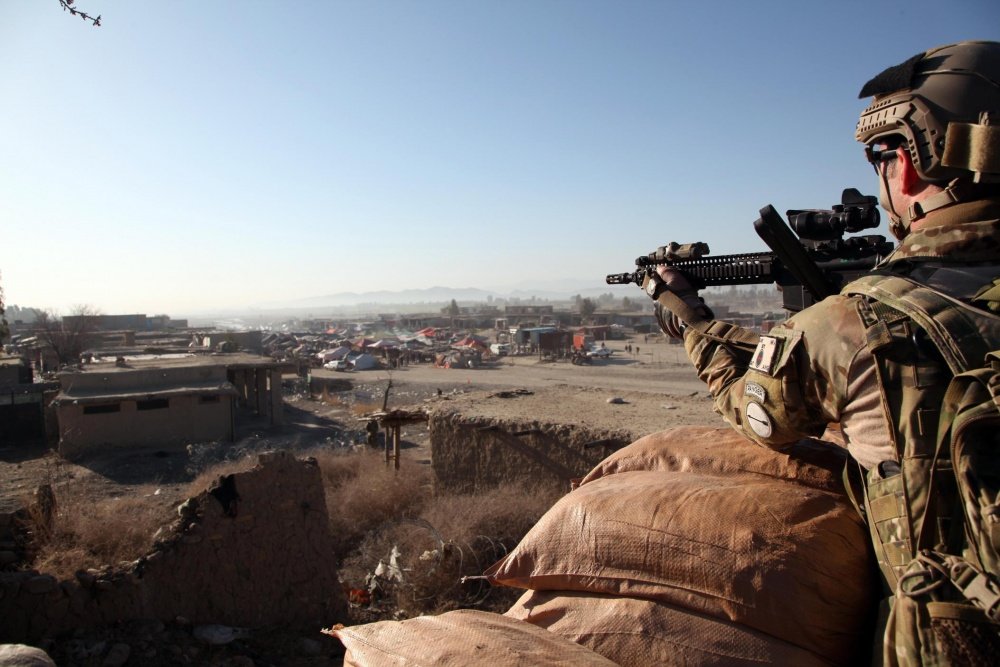 U.S. Army Maj. Tommy Broome, an operational adviser with the Asymmetric Warfare Group, provides security from an observation post overlooking the Kholbesat bazaar, in Khowst province, Afghanistan, March 13, 2011. Photo by Maj. Sonise Lumbaca via DVIDS.