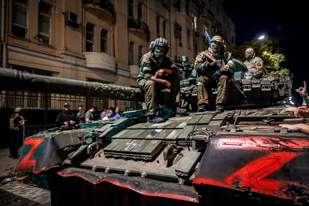 Members of the Wagner Group military company sit atop of a tank on a street in Rostov-on-Don.