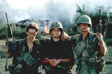 From the left, Willem Dafoe, Charlie Sheen, and Tom Berenger on location while filming Platoon in 1986. Photo courtesy of Pictorial Press Ltd./Alamy Stock Photo.