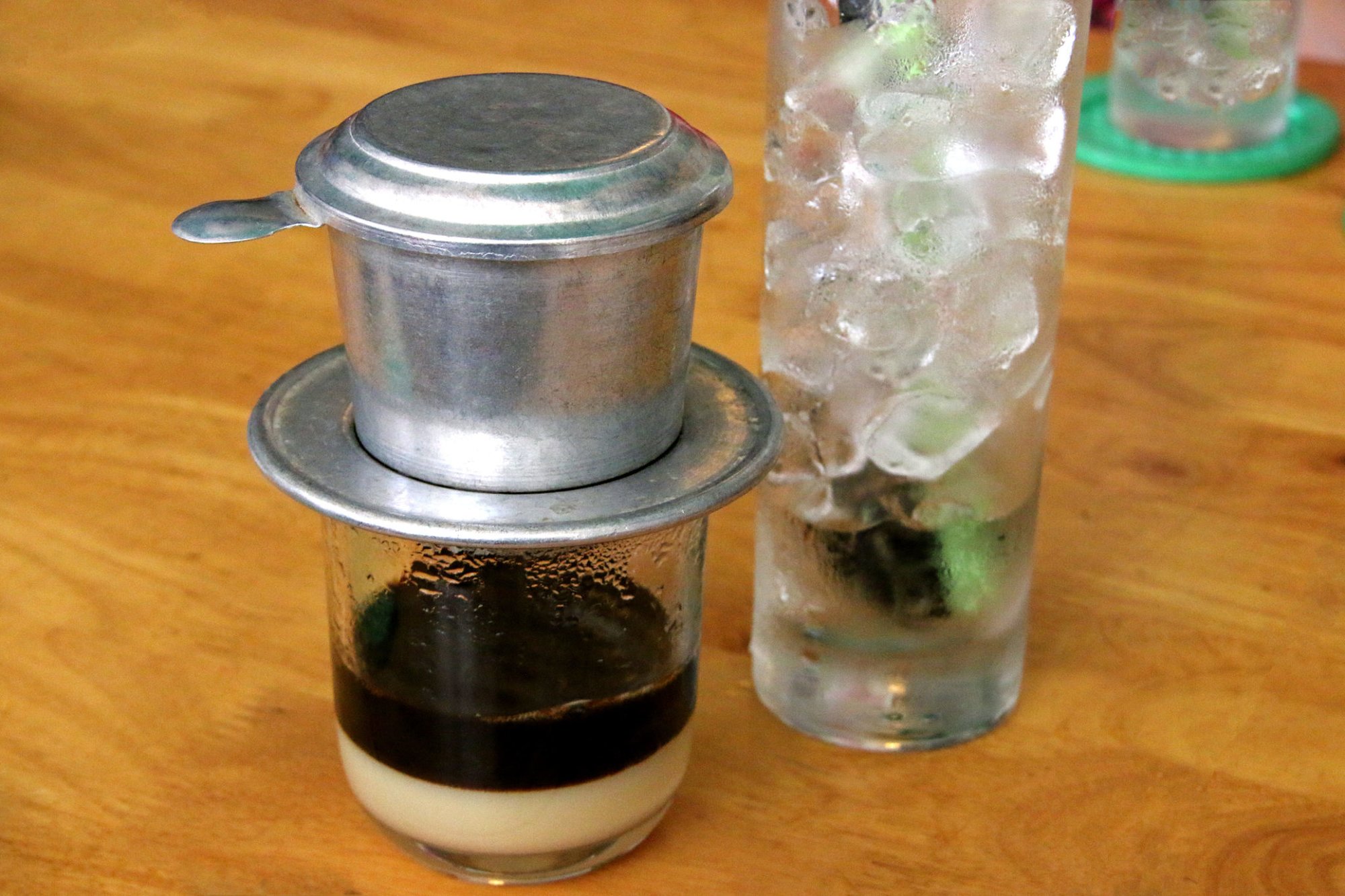 A Vietnamese iced coffee brewing through a filter. Photo via Getty Images.