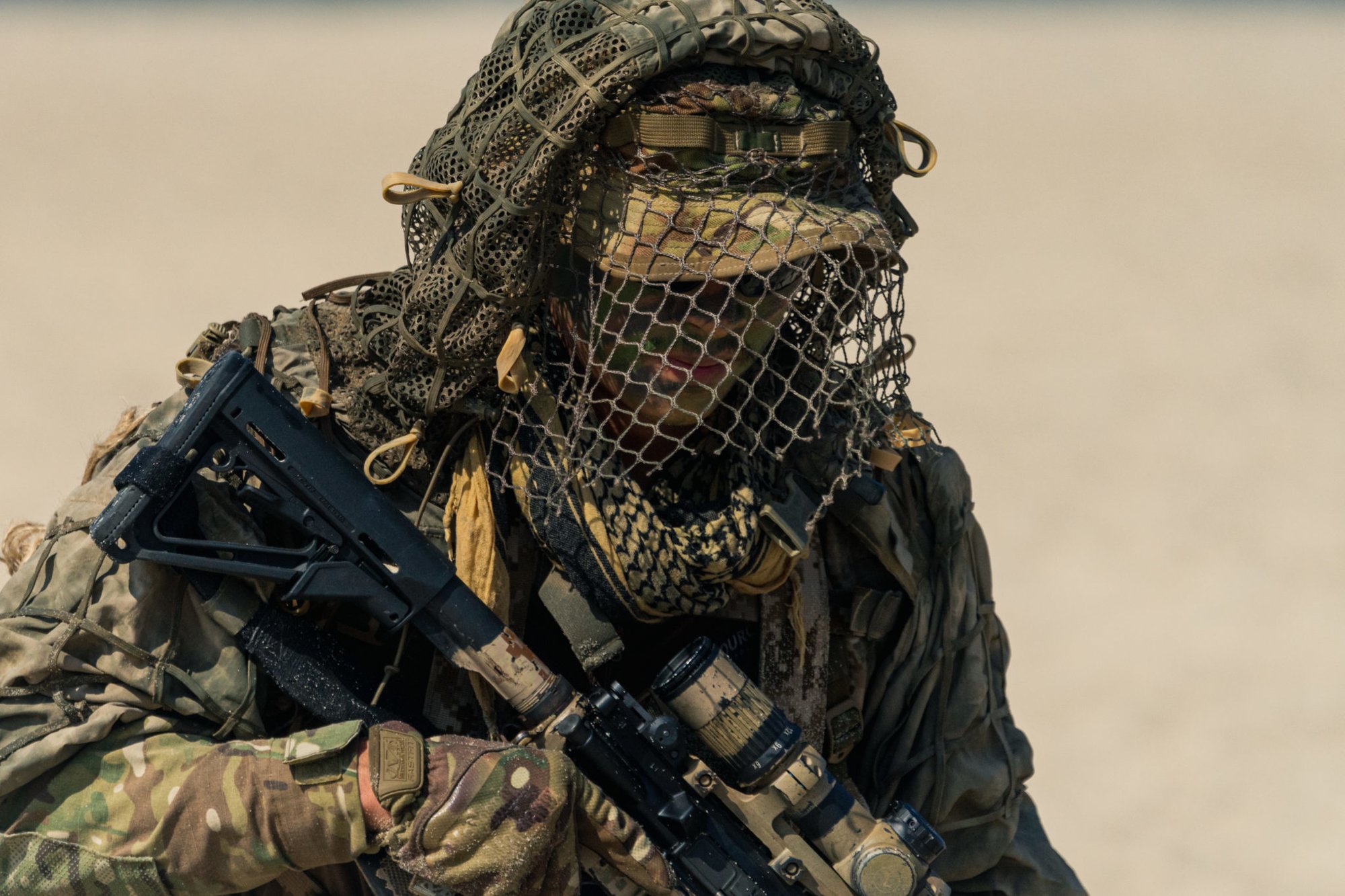 A Navy SEAL from Naval Special Warfare Group 2 moves from his beach side hide site during a capabilities exercise. Photo by Marty Skovlund, Jr./Coffee or Die.