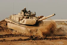 An Iraqi Army tanker with the 9th Armored Division drives an M1A1 Abrams tank under the instruction of soldiers with Company C, 1st Battalion, 18th Infantry Regiment, 2nd Advise and Assist Brigade, 1st Infantry Division, United States Division-Center Jan. 16, 2011, at Camp Taji, Iraq. US Army photo by Sgt. Chad Menegay.