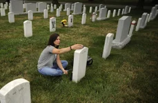 Stacy Pearsall visits her fallen brother, Army Staff Sgt. Alan W. Shaw, in Section 60 of Arlington National Cemetery July 18, 2011. Shaw was killed in Baqubah, Iraq, Feb. 9, 2007. Photo by Andy Dunaway.