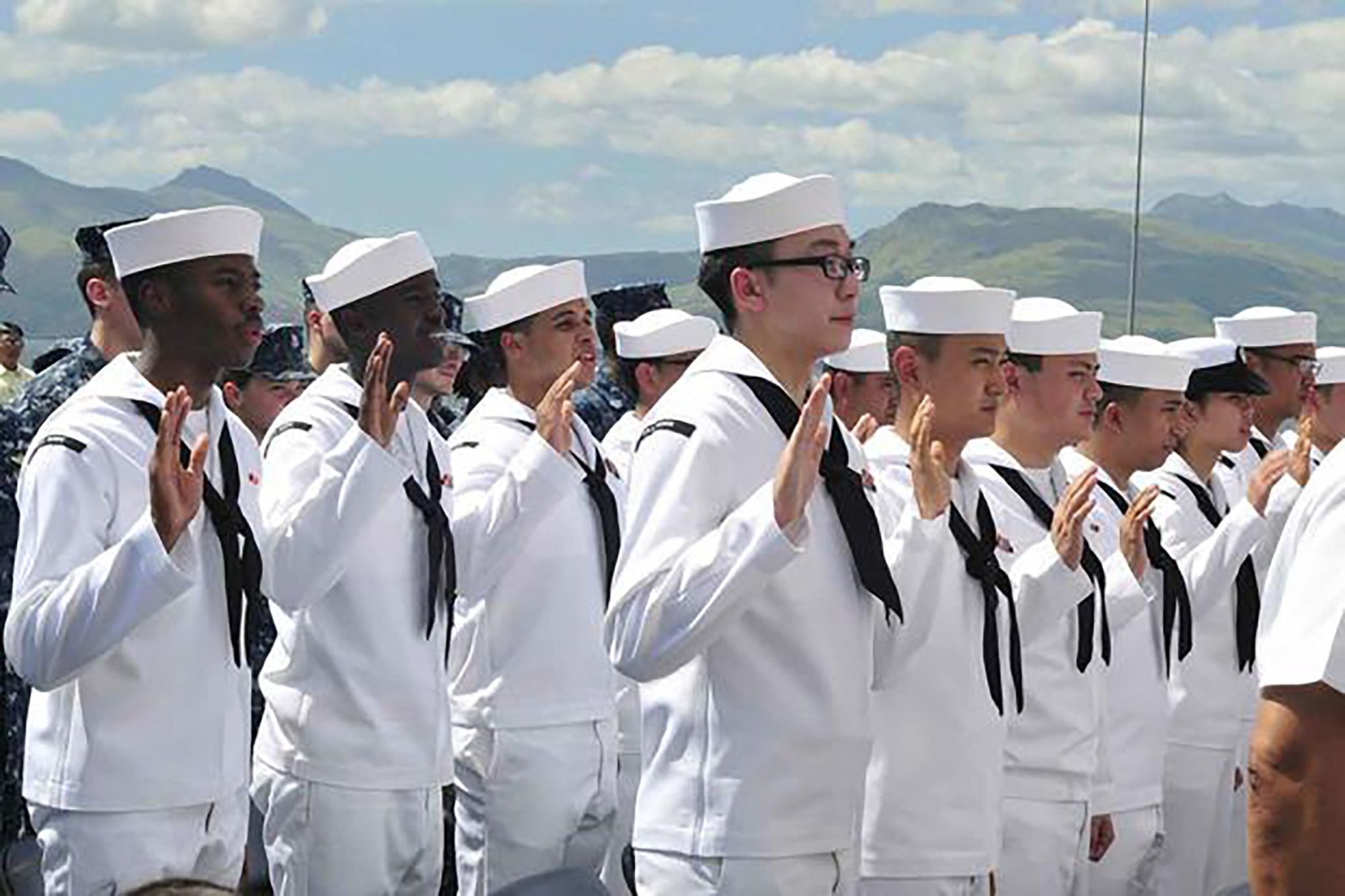 Sailors take the oath of allegiance during a naturalization ceremony aboard the forward-deployed amphibious assault ship USS Essex. Photo by Mass Communication Specialist 1st Class Terry Matlock.