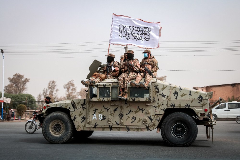 Taliban fighters patrol on the road.